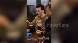 Woman captures the 'horrifying' moment a man dips his Domino's pizza into a pint of Guinness