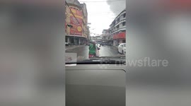 Huge snake emerges on car bonnet in busy traffic