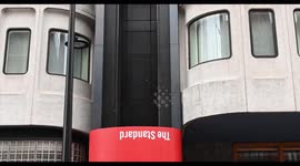 The wonderful Red Lift coming down outside of 'The Standard' Hotel in Central London