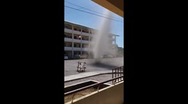 Dust devil tornado whips through school court yard