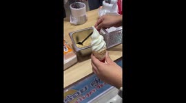 Ice cream falls from cone into bowl of of toppings