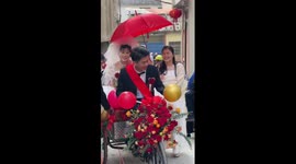 Bride and groom ride vintage tricycle at wedding in China