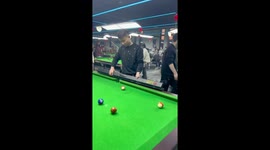 Player pulls out homemade pool cue fashioned from a wooden stake