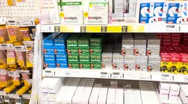 Vapes displayed in queue at general shop in UK despite nicotine warning and recent studies stating they cause similar DNA damage as Cigerettes
