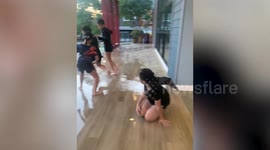 Excited puppy slides into swimming pool with kids