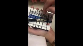 Chinese woman crafts miniature string instrument using elastic bands and box