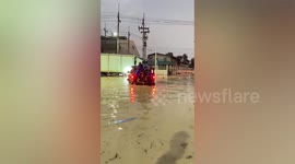 Workers crowd onto truck to escape knee-high floods in Thailand