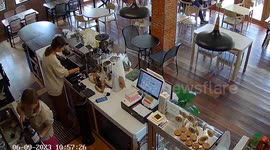 Coffee beans scatter on cafe counter when jar breaks