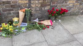 People leave flowers and tributes outside the Russian Embassy in London for victims of ISIS attack in Moscow