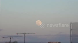 The March Full Moon known as the Worm Moon rises over the London Docklands