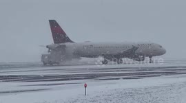 Delta Airlines plane de-iced during snow storm in New York