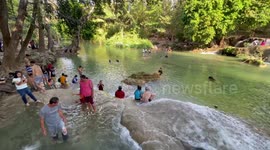 Locals cool off at waterfall as temperatures reach 40C in Thailand