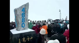 Tourists fight over photo position at snowy mountain top in southern China