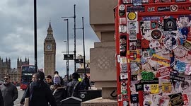 Overflowing with Character: London Phone Box Covered in Stickers and Litter