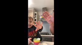 Little boy learns the secret ingredient to the perfect cookies while baking with dad