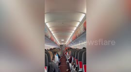 Air Asia flight attendant sings to entertain passengers
