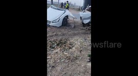Out-of-control car splits in two after colliding with road sign