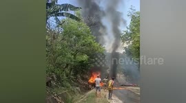 Seventeen dead when van crashes into dump truck and bursts into fire