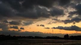 Time-lapse footage of a glowing, orange sunset in China