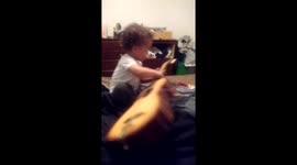Grand baby playing guitar