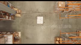 Top shot of fork lift truck picking up a palette and driving away