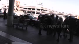 Guns N' Roses' Axl Rose rides scooter through LAX airport after breaking foot