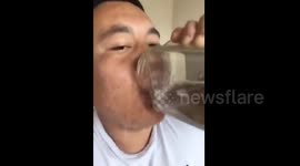 Man drinks live fish, frogs and tadpoles with water