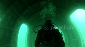 Diver explores plane wreckage at the bottom of the ocean