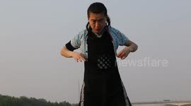 Kung fu man wears three-year-old child's clothes on