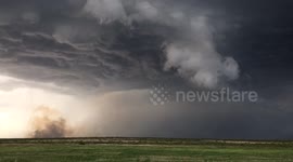 Smoke from a lightning fire being sucked into storm