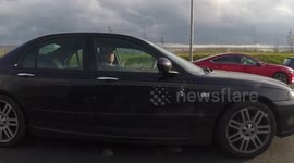 Old Man Checking FaceBook while driving M50 Dublin Ireland