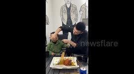 Father Feeds Kid Barbecue in a Distinctive Way in Yili,, China