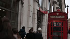 Looking at the famous London Telephone Box in Soho, United Kingdom