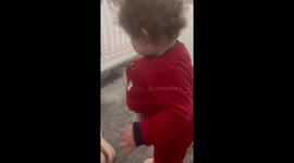 Snug as a bug: Toy baby decides to play hide-and-seek in baby girl's t-shirt