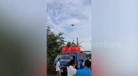 Drone carries firecrackers into air during wedding
