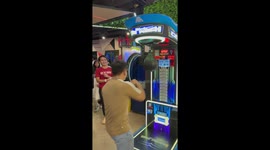 Show off swings at boxing machine but misses punchbag