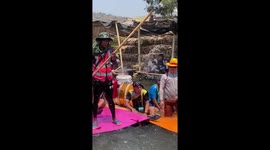 Reveller plays drum kit on floating river raft