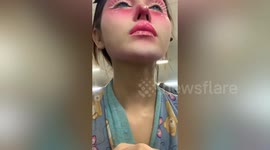 Thai man wears colourful makeup to look like a doll