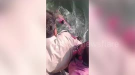 Police rescue youths after they fell into canal while taking bath in northern India