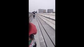 Passengers forced to walk along tracks when train breaks in Thailand