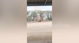 Dust devil whirls across field in Thailand