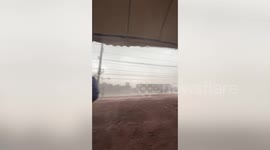Locals hold down tent legs as storm batters Thailand