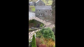 Rural harmony: shepherd, dogs, and flock in Ambleside