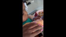 Determined diner: toddler rejects sleeve help in adorable standoff