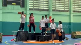 Teacher trips over on stage while dancing at school gym