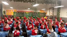 Chinese teacher inventively entertains pupils with unique desk dance during recess