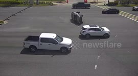 Drivers work together to push overturned SUV back upright