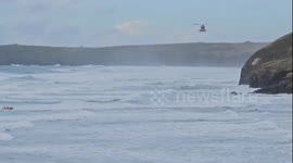 Video shows dramatic rescue after dog walker falls into the sea