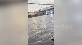 Heavy rain turns road into a canal in southern Thailand