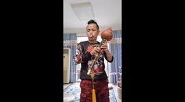 Chinese musician stuns by playing large flute just using his EARS